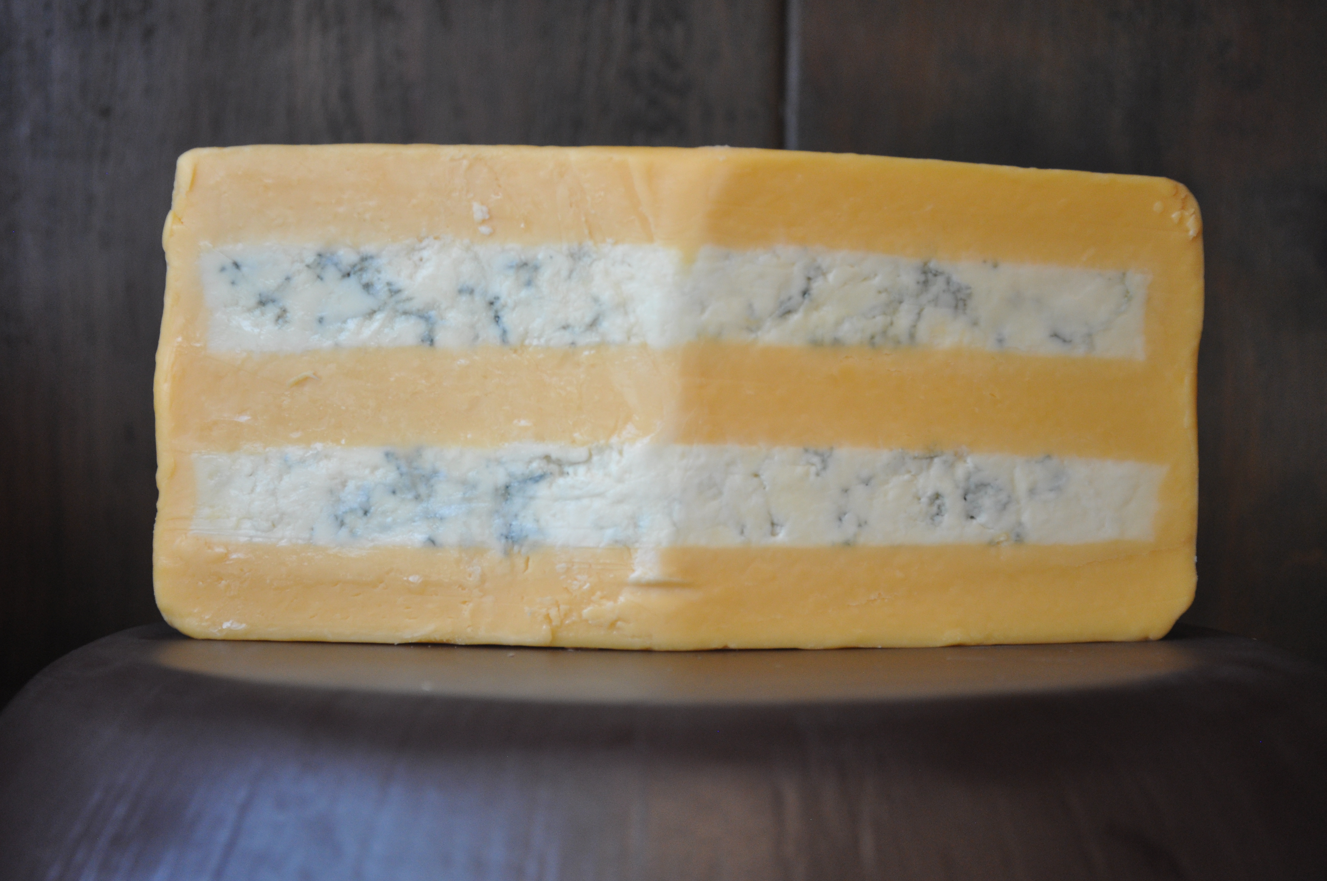 Slice of Huntsmen cheese showing Gloucester and Stilton layers
