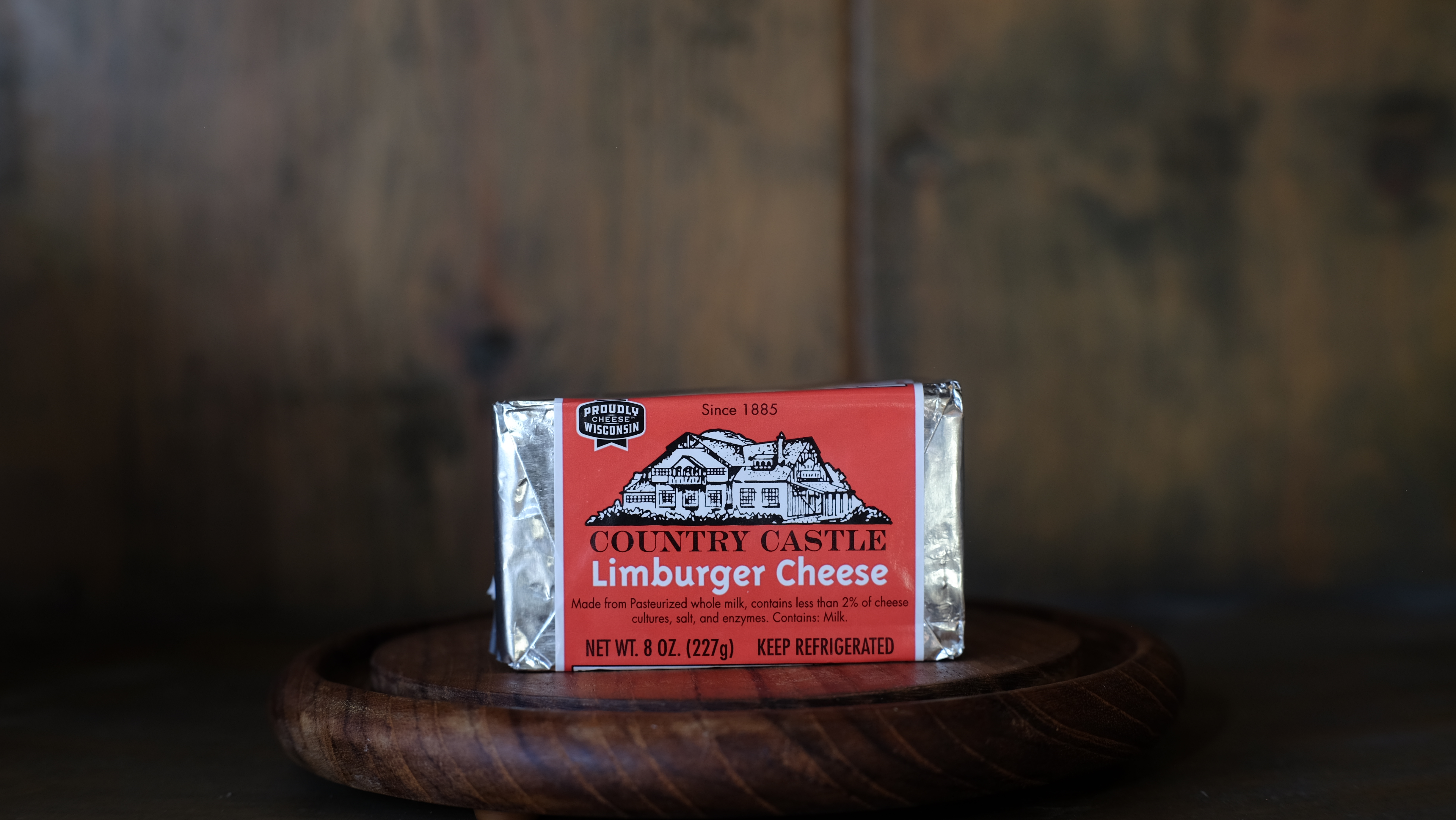 Block of soft Limburger washed-rind cheese on parchment paper